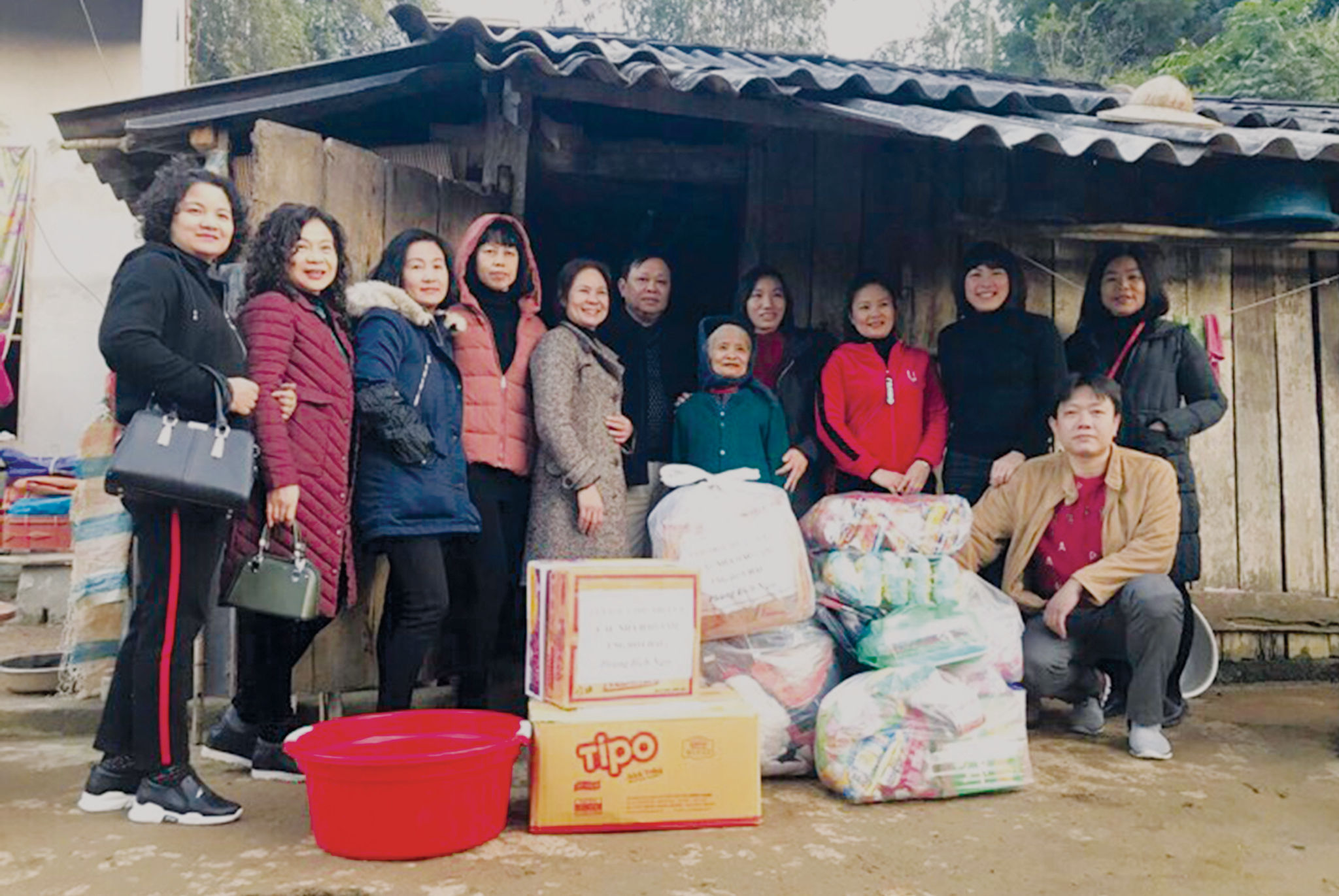 Ông Thảm (đứng thứ 6 từ trái qua) cùng các nhà hảo tâm trao quà cho người già ở xã Hoa Thám, huyện Bình Gia.