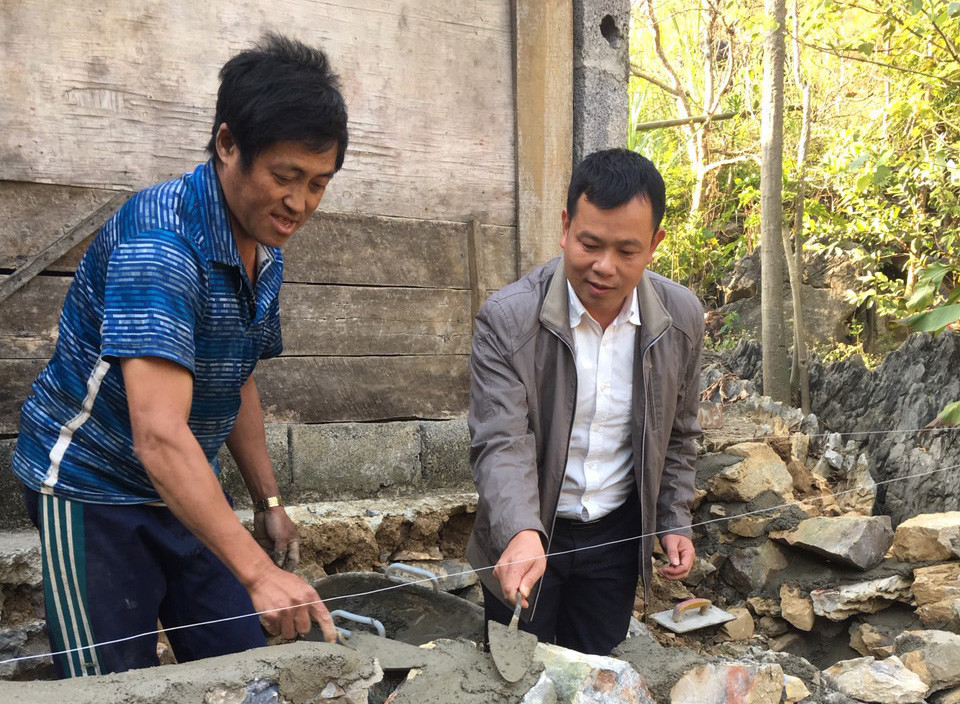 Anh Lý Văn Châư hướng dẫn người dân xóm Nà Sác sửa chữa nhà đón Tết.