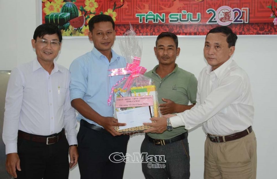 Đại diện lãnh đạo Ban Dân tộc tỉnh Cà Mau tặng quà cho cán bộ, viên chức là người dân tộc Khmer tại Báo Cà Mau. (Ảnh: baocamau.com.vn)