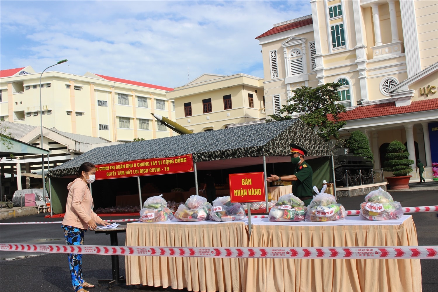 Cán bộ Cục Chính trị hướng dẫn người dân nhận hàng tại “Gian hàng 0 đồng”
