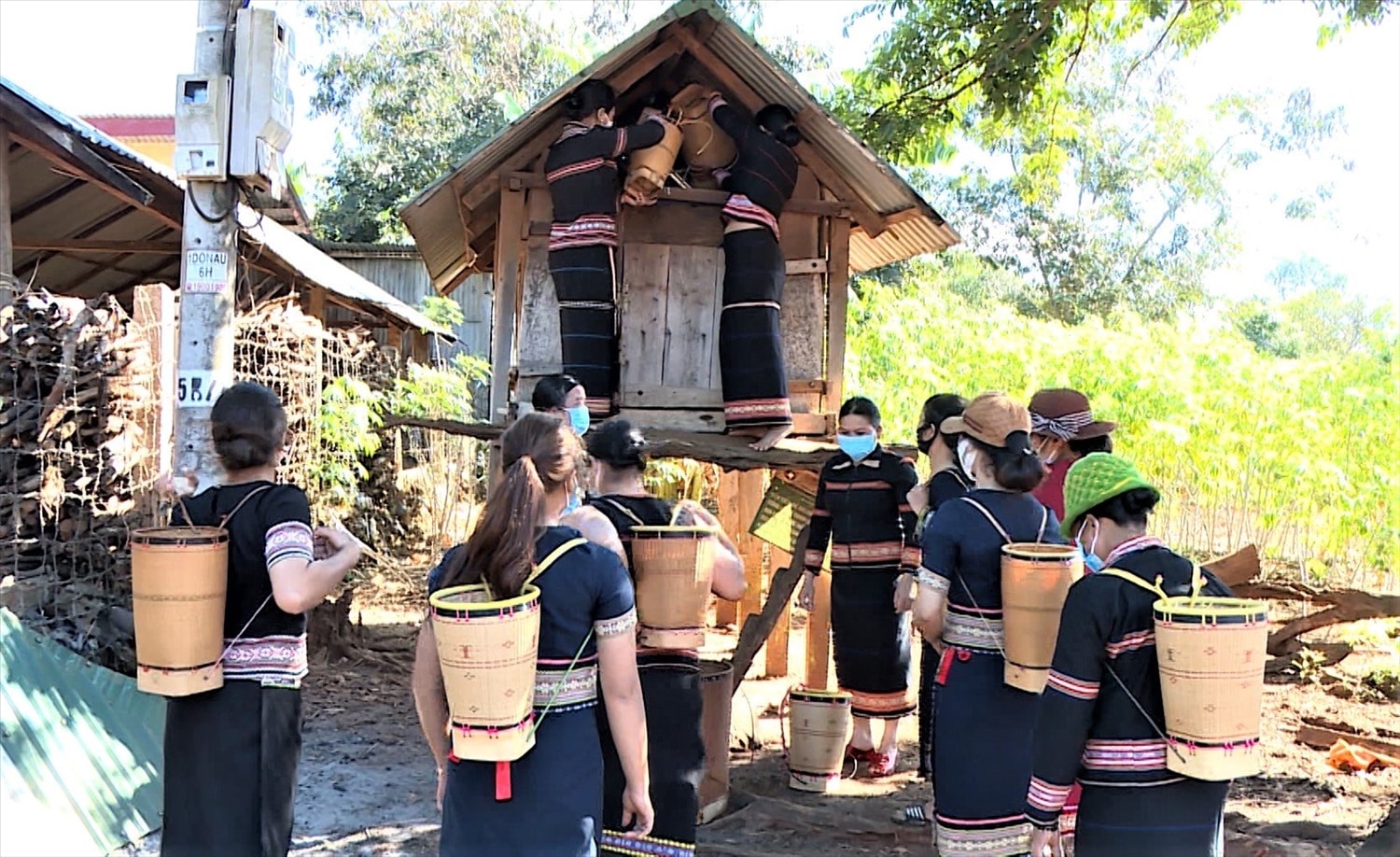 Rất đông gia đình mang thóc đến kho thóc tình thương của làng để đóng góp