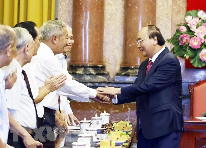 Chủ tịch nước Nguyễn Xuân Phúc với các cán bộ từng phục vụ và bảo vệ Bác Hồ. (Ảnh: TTXVN)