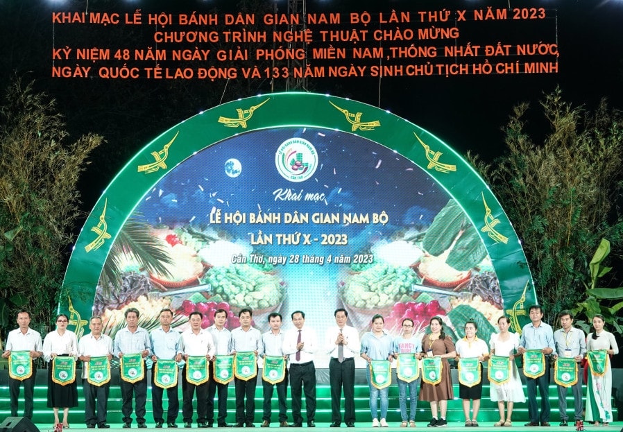 Ông  Lê Quang Mạnh, Bí thư Thành ủy Cần Thơ ( đứng giữa bên trái) và ông Phạm Văn Hiểu, Phó Bí thư Thường trực Thành ủy, Chủ tịch HĐND TP Cần Thơ ( đứng giữa bên phải), trao cờ lưu niệm cho các đơn vị tham gia Lễ hội