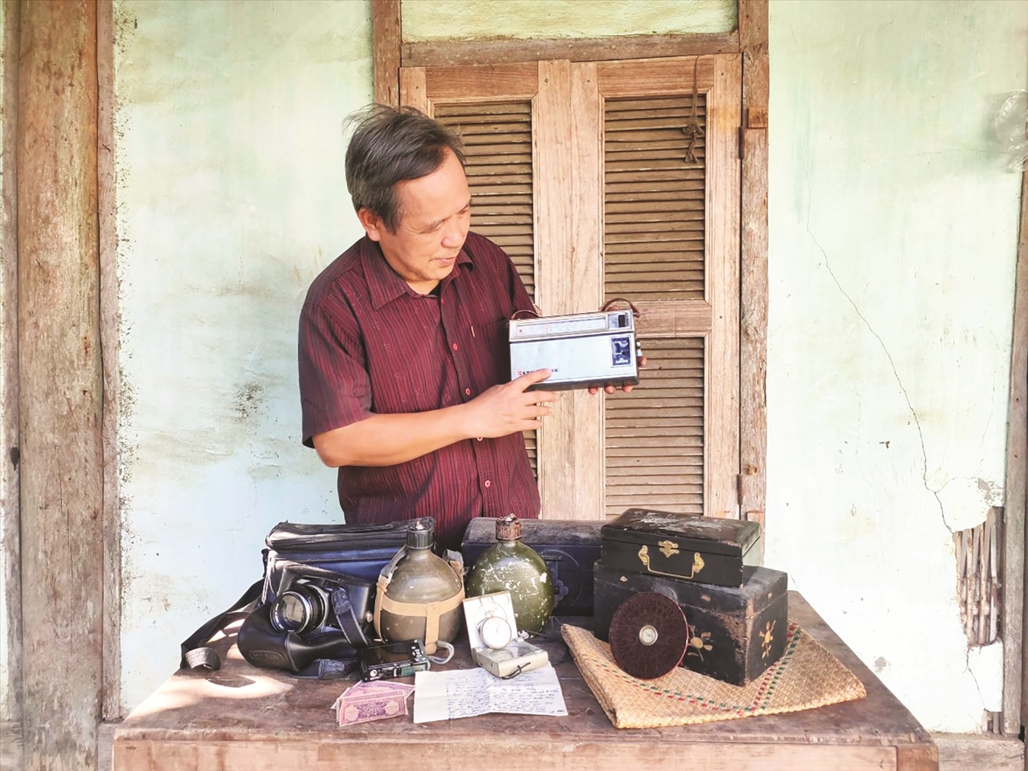 Ông Nguyễn Quang Vĩnh với kỷ vật còn lưu giữ được. Ông Nguyễn Quang Vĩnh với kỷ vật còn lưu giữ được.