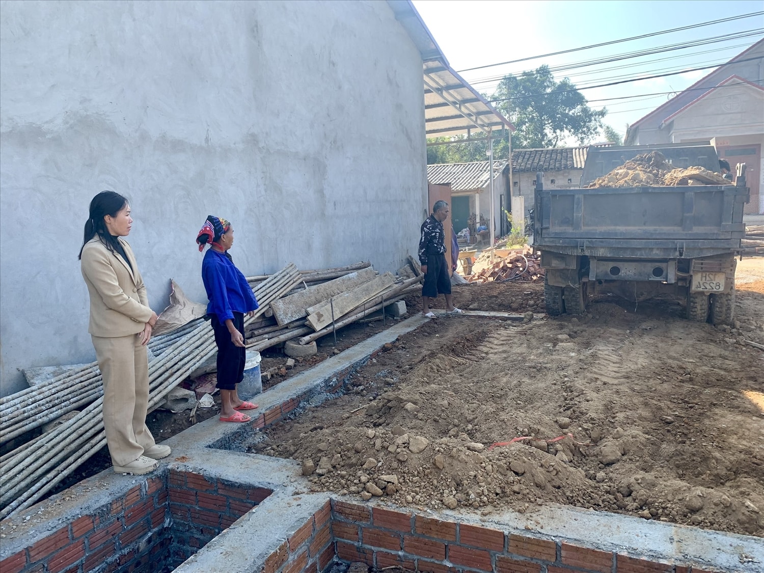 Chủ tịch UBND xã Chiến Thắng Đàng Thị Luyên  (đầu tiên bên trái) kiểm tra tiến độ làm nhà hộ gia đình ông  Hoàng Văn Héo
