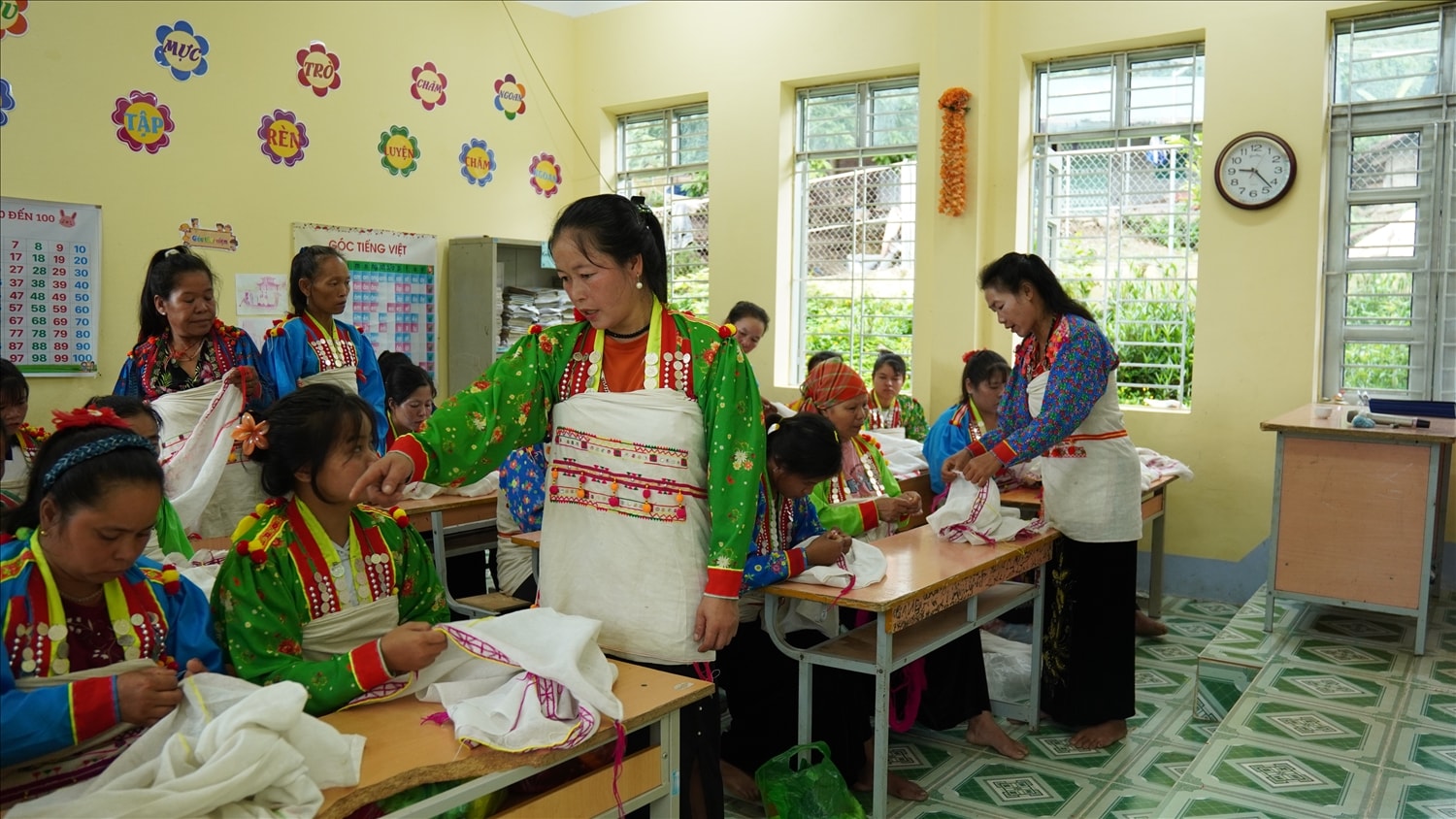 Các nghệ nhân hướng dẫn các học viên tại lớp tạo hình trang phục dân tộc Mảng tại bản Huổi Van, xã Nậm Hàng