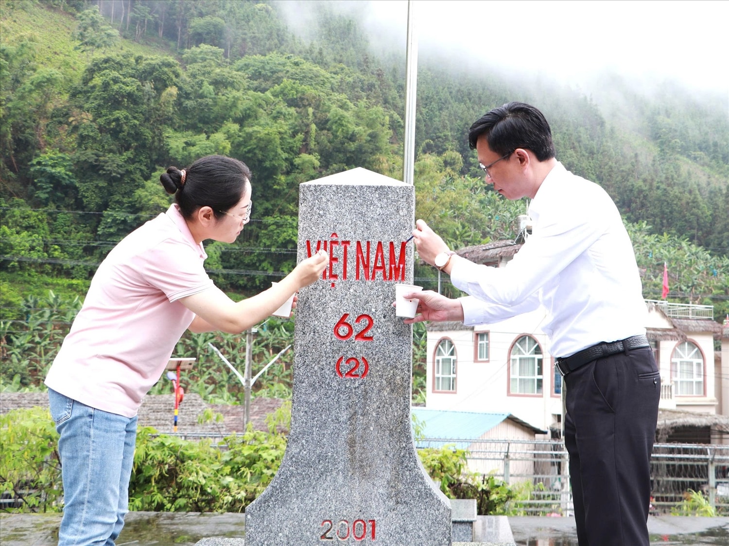 Đồng chí Kiều Hải Nam - Giám đốc Sở Ngoại vụ tỉnh Lai Châu và đồng chí  Lưu Phương - Phó Ban Ngoại vụ Chính quyền nhân dân châu Hồng Hà tô sơn tại mốc giới số 62(2).
