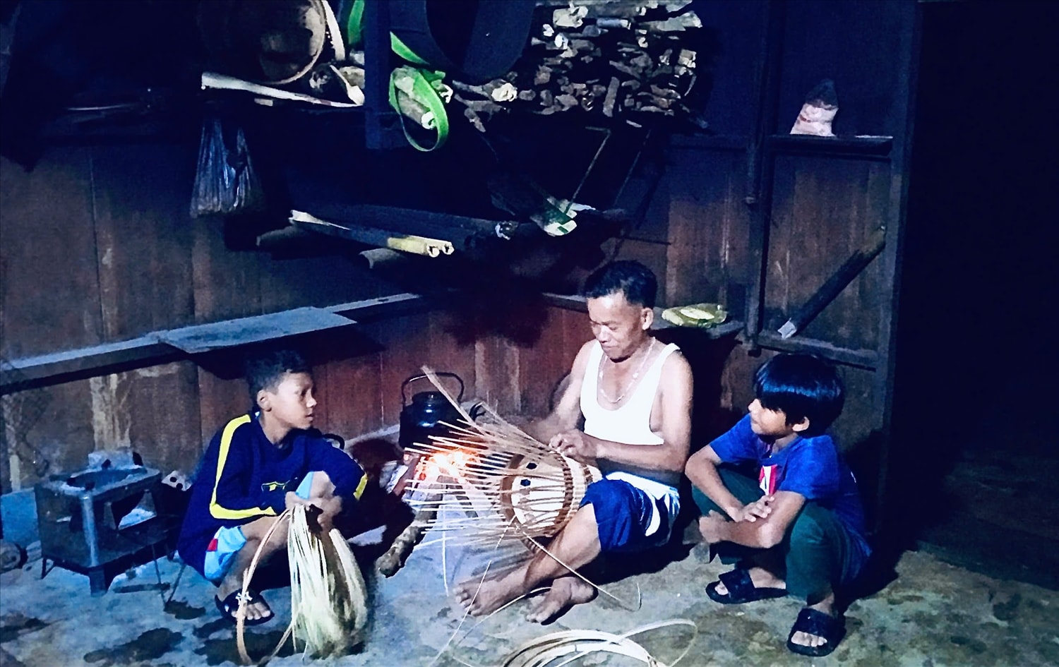 Những ngày cuối tuần, lúc rảnh rỗi, ông Đa thường gọi con cháu, những đứa trẻ Cơ Tu trong thôn về nhà mình để truyền nghề đan lát. Ảnh: Văn Sơn