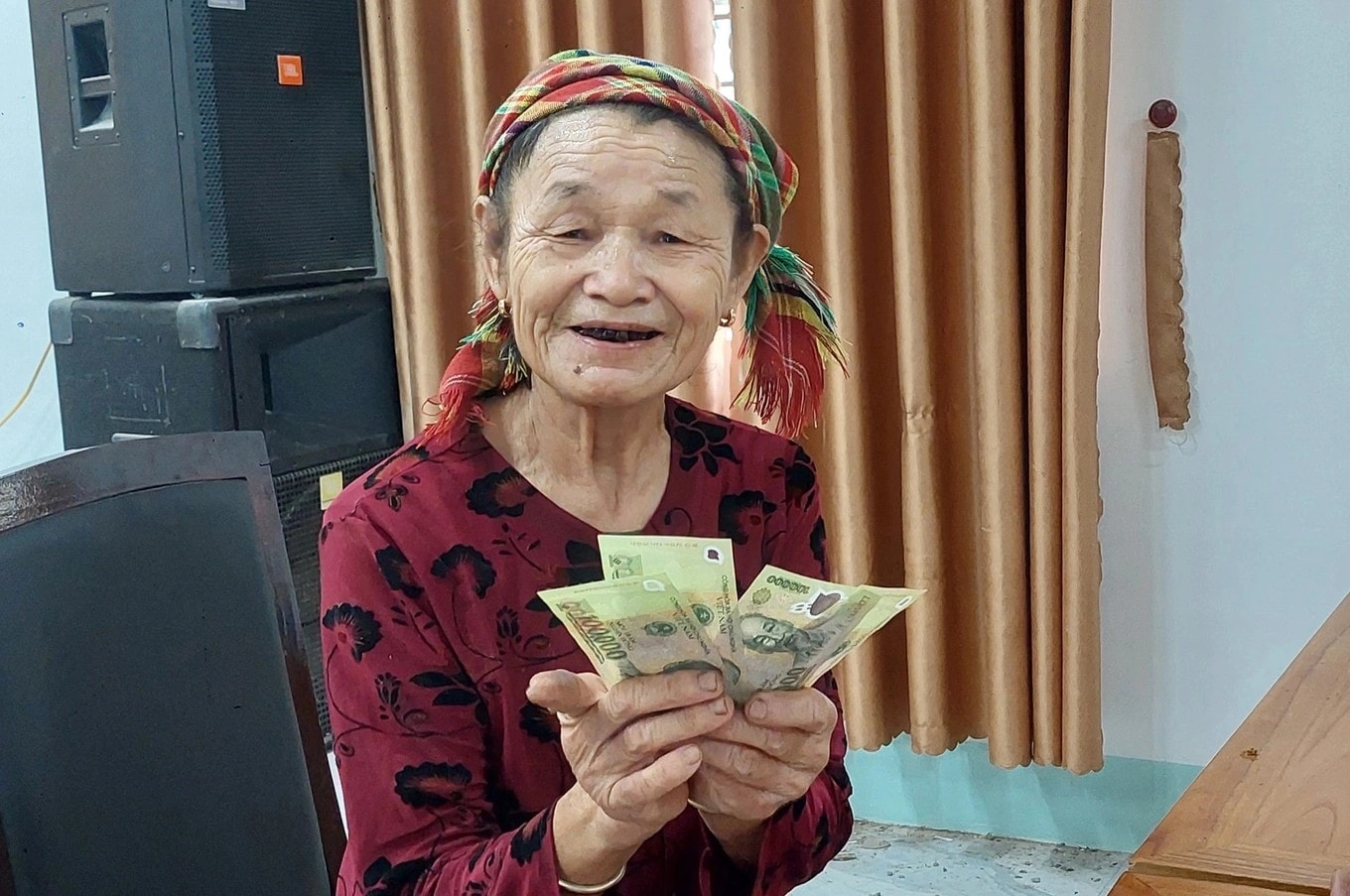 Cầm trên tay món tiền của Đảng và Nhà nước trao tặng dịp Quốc khánh, bà Vi Thị Miên (70 tuổi), trú tại bản Quang Vinh xã Tiền Phong rất  xúc động - Ảnh: CSCC