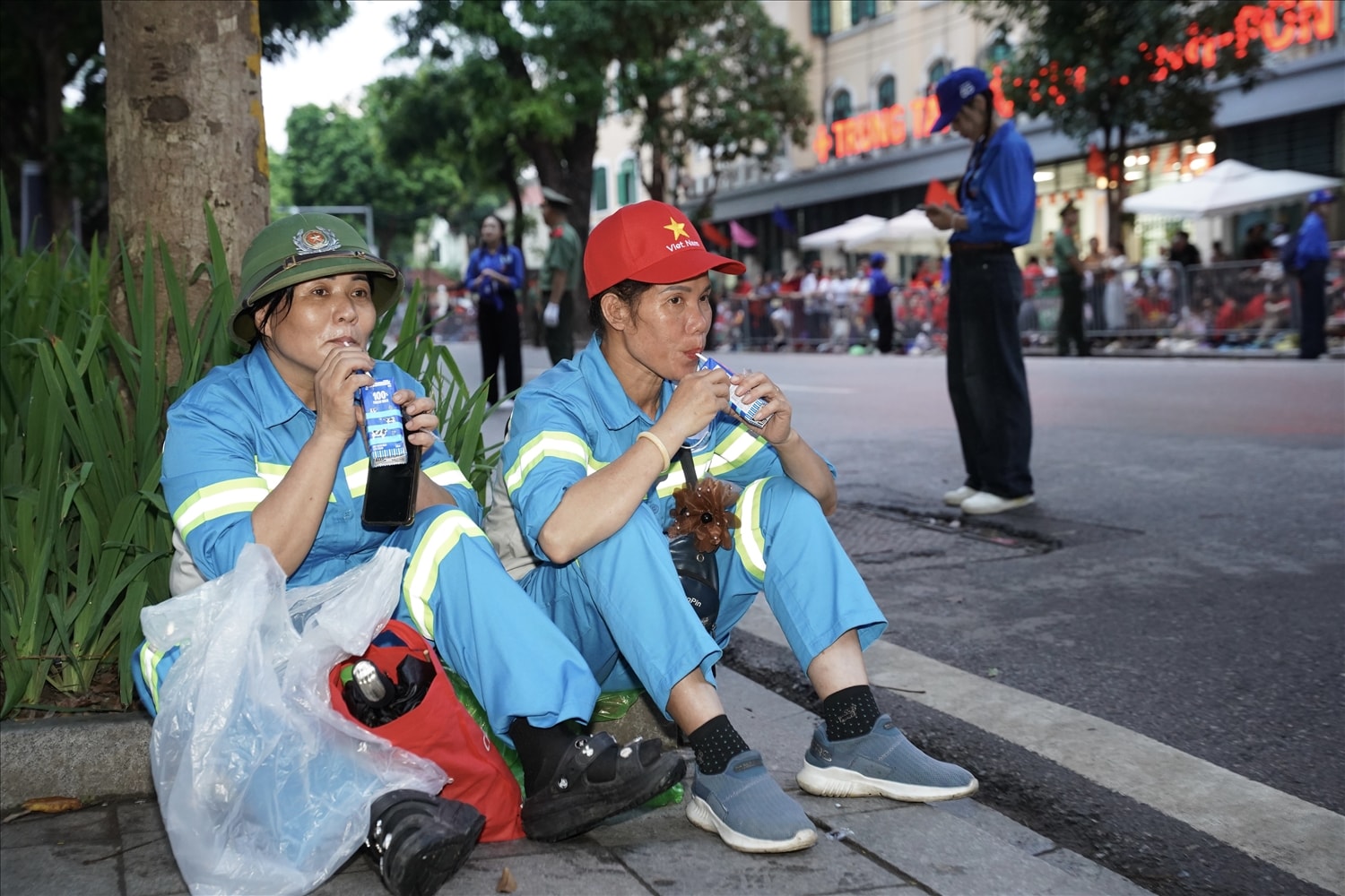 Phút nghỉ ngơi và tiếp thêm chút năng lượng bằng sữa tươi Vinamilk của các chị góp phần quan trọng để đại lễ diễn ra với những tuyến đường sạch sẽ, ngăn nắp. (Ảnh: Vi Nam) 