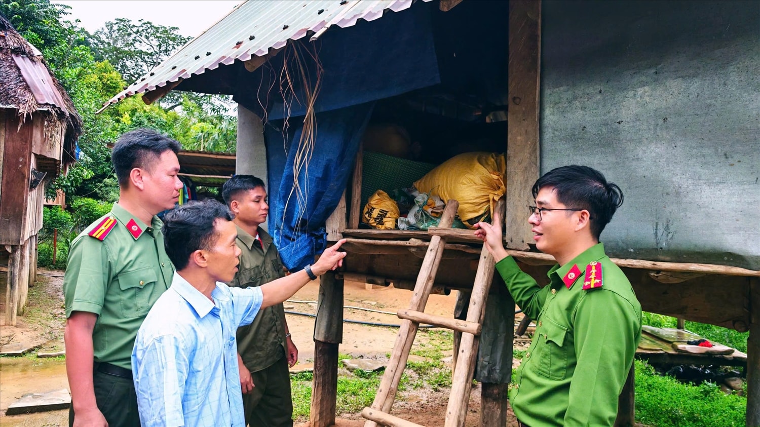 Lực lượng chức năng xã A Vương hướng dẫn người dân chủ động ứng phó với mưa bão. (Ảnh A Quân).