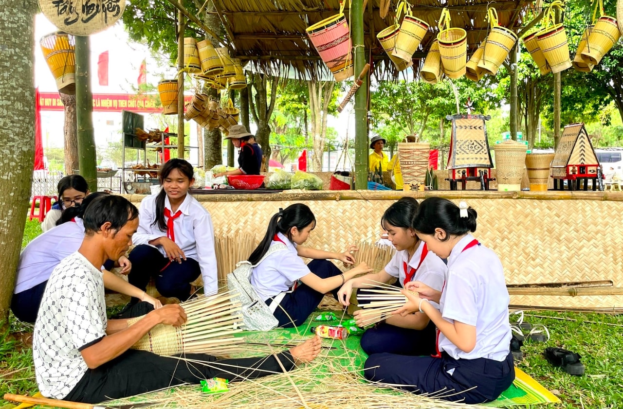 Tại “Ngày hội Di sản văn hóa”, các em học sinh có dịp tìm hiểu về nghề truyền thống của  các dân tộc. (Ảnh: L.N)