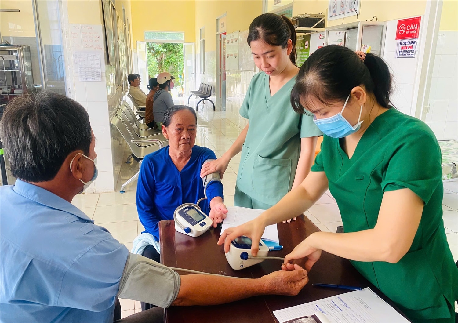 Nhân viên y tế khám sàng lọc, đo huyết áp và tư vấn sức khỏe cho người dân tại tuyến cơ sở