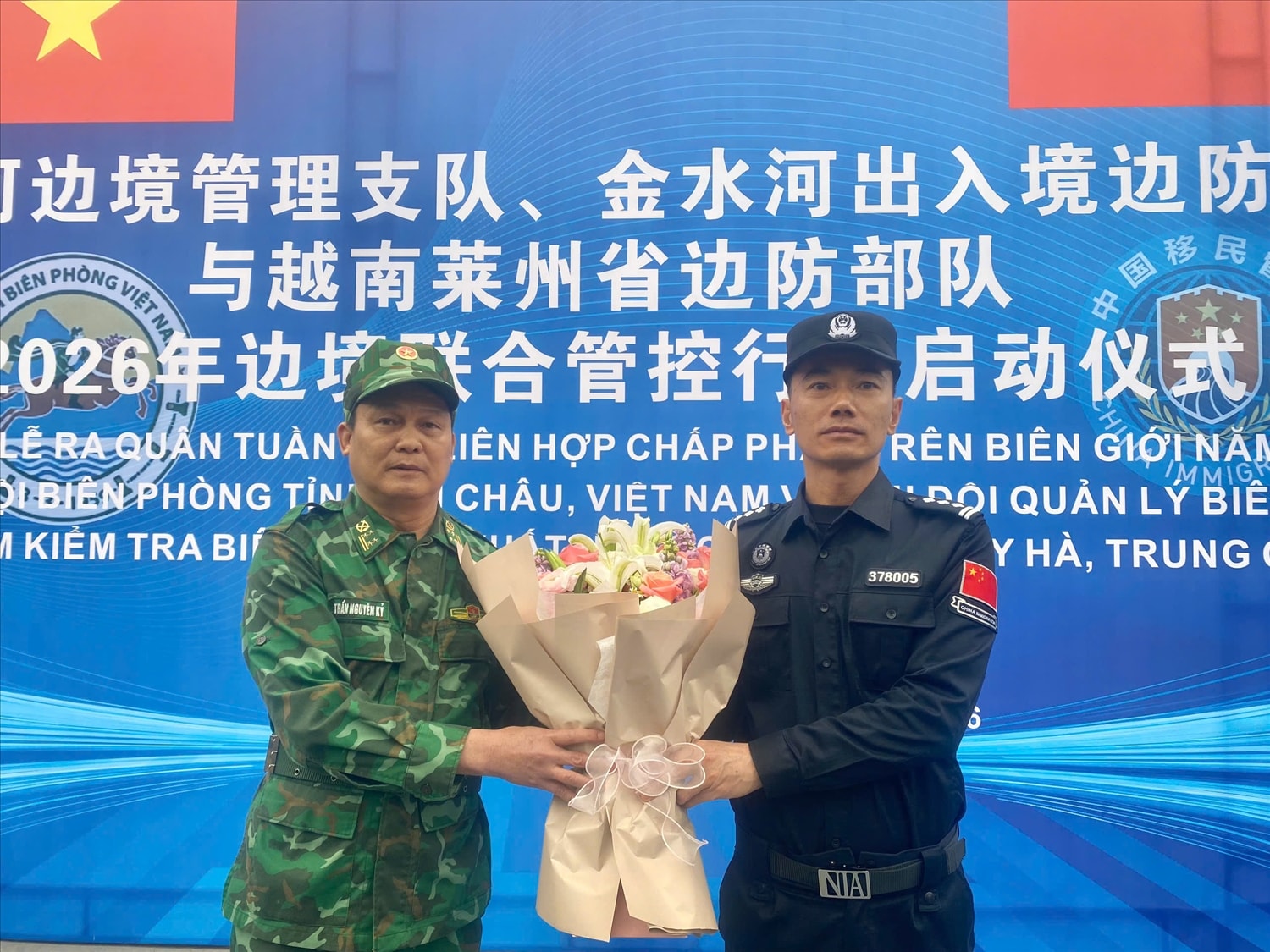 Đại tá Trần Nguyên Kỷ - Phó Chỉ huy trưởng Ban Chỉ huy BĐBP tỉnh Lai Châu, Chỉ huy trưởng tuần tra liên hợp phía Việt Nam tặng hoa Phó Chi đội trưởng Chi đội Quản lý biên giới Hồng Hà Nhiếp Phát Toàn - Chỉ huy trưởng phía Trung Quốc