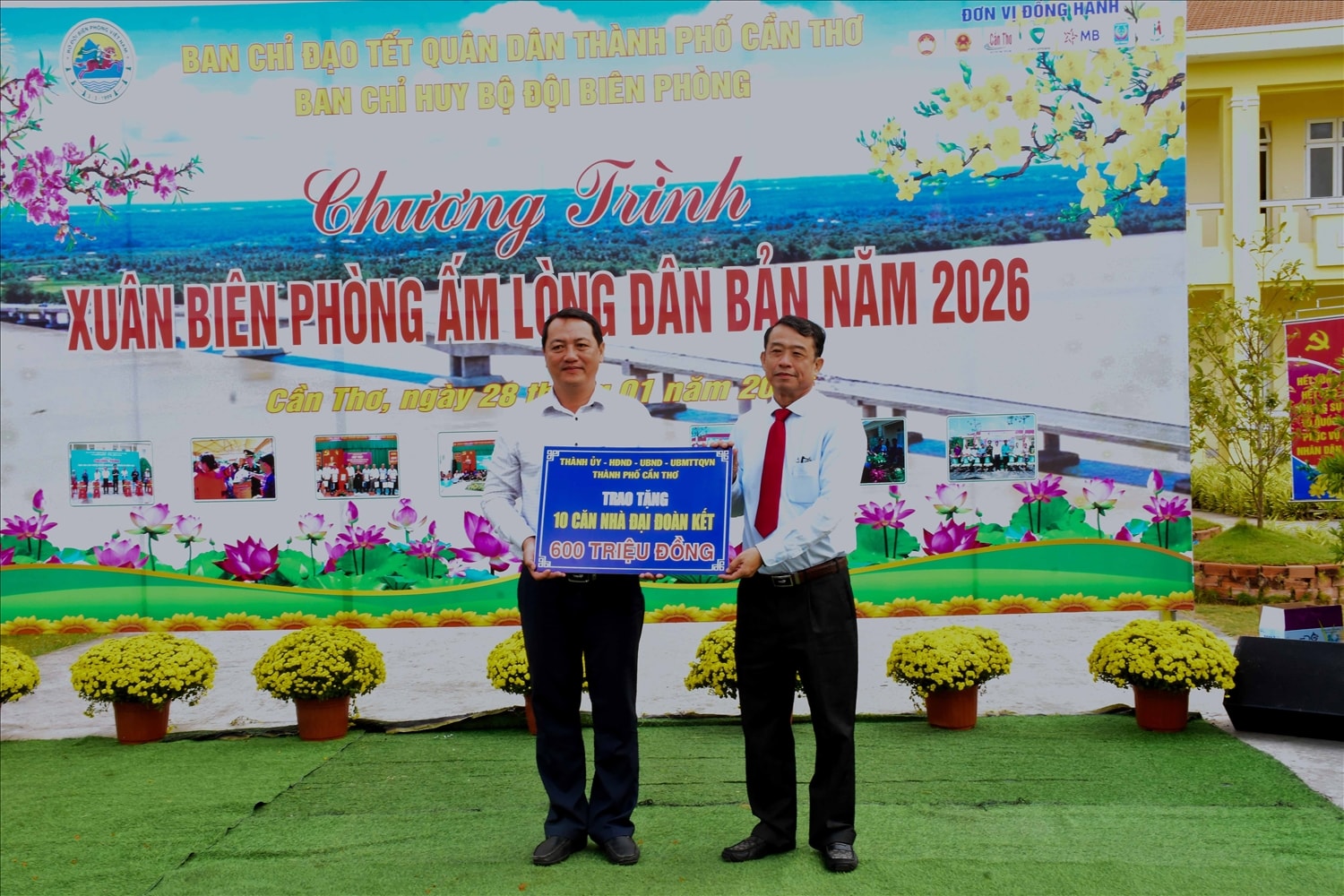 Ông Nguyễn Văn Khởi, Phó Chủ tịch UBND thành phố Cần Thơ (bên phải) trao bảng tượng trưng tặng 10 căn nhà Đại đoàn kết cho các hộ gia đình có hoàn cảnh khó khăn trên địa bàn xã Cù Lao Dung.