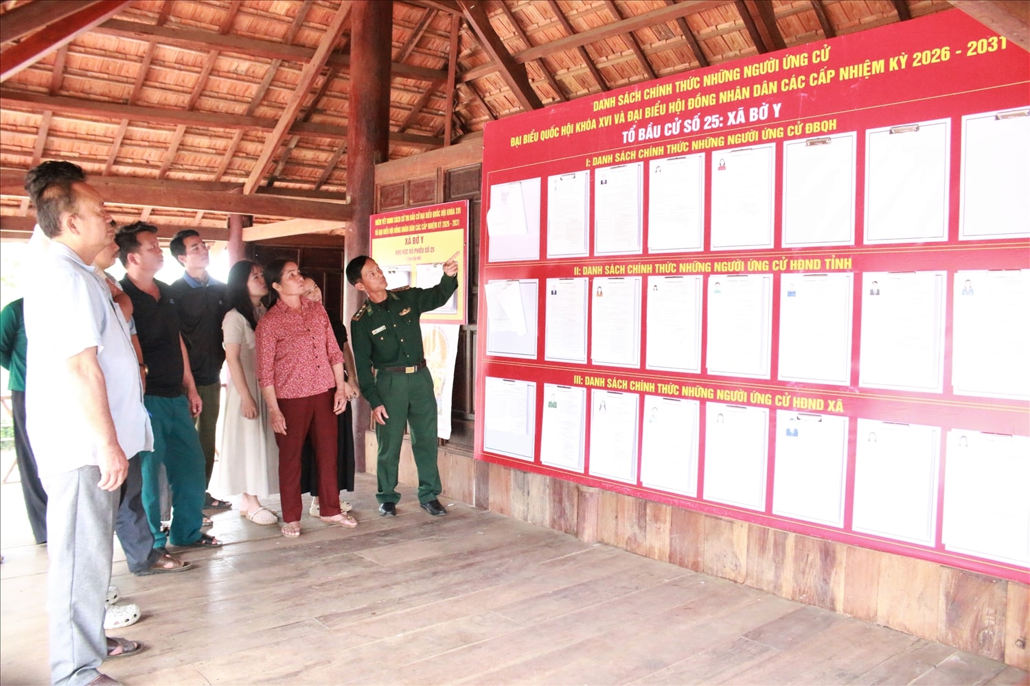 Đồng bào Brâu ở làng Đăk Mế đến nhà rông của làng tìm hiểu về tiểu sử các ứng cử viên đại biểu Quốc hội và đại biểu HĐND các cấp. (Ảnh: Ngọc Chí)