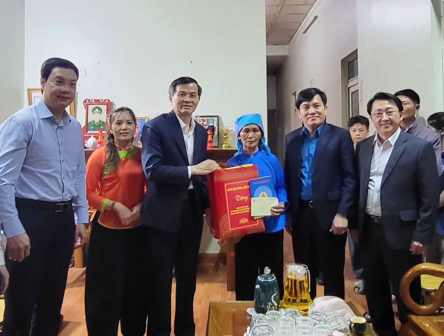 Đồng chí Đoàn Minh Huấn thăm, tặng quà bà Hù Thị Sắng là mẹ Liệt sỹ Nùng Văn Dính (Ảnh Cổng TTĐTLC)