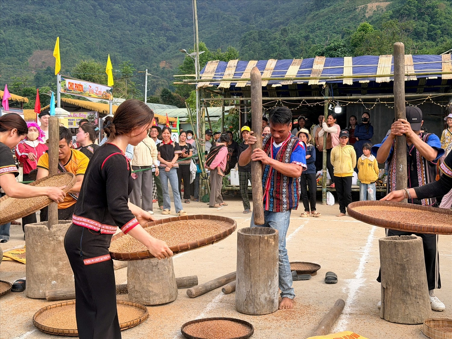 Du khách hoà mình cũng người dân địa phương trong nhịp chày giã lúa tại chợ phiên. (Ảnh MQ)