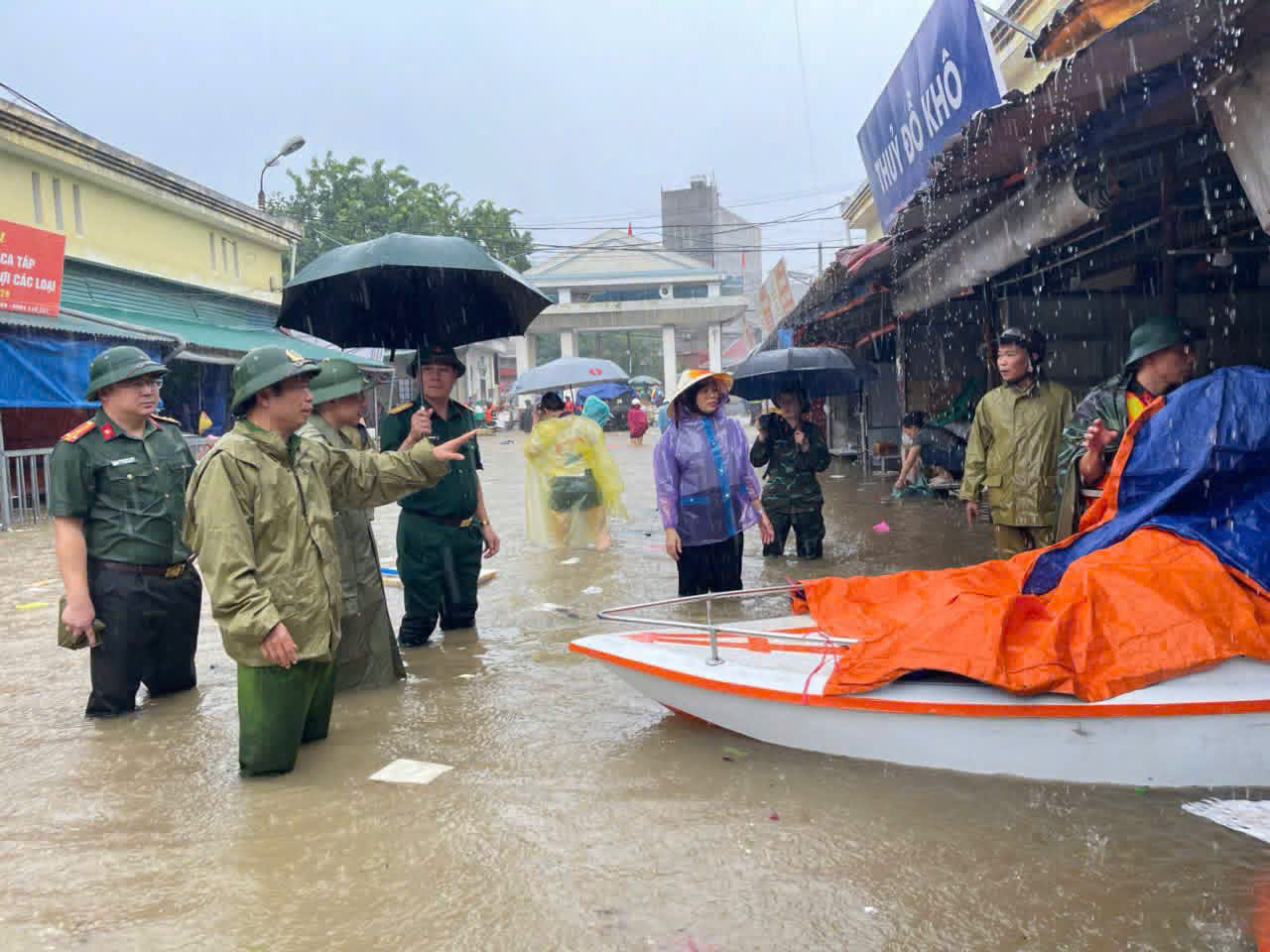 Cán bộ chiến sĩ công an, quân đội hỗ trợ người dân cứu trợ hàng hoá tại chợ Giếng Vuông ra khỏi nơi ngập, lụt. Ảnh: Công an Lạng Sơn